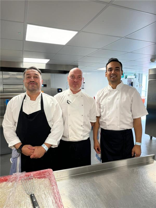 A group of male chefs in a kitchen