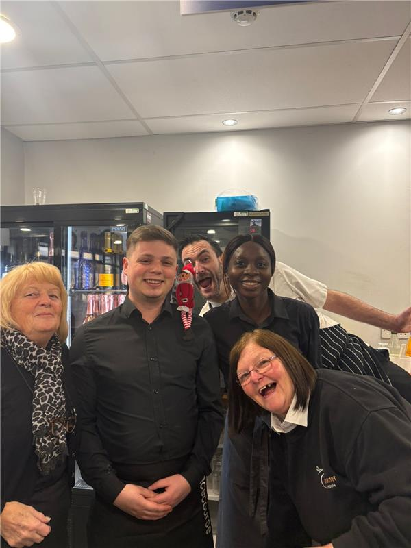 A group diverse of Hospitality workers smiling and having fun at work