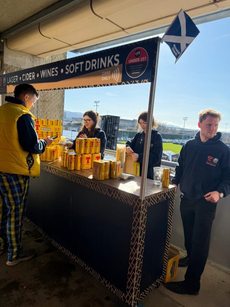 Workers serving drinks at an event